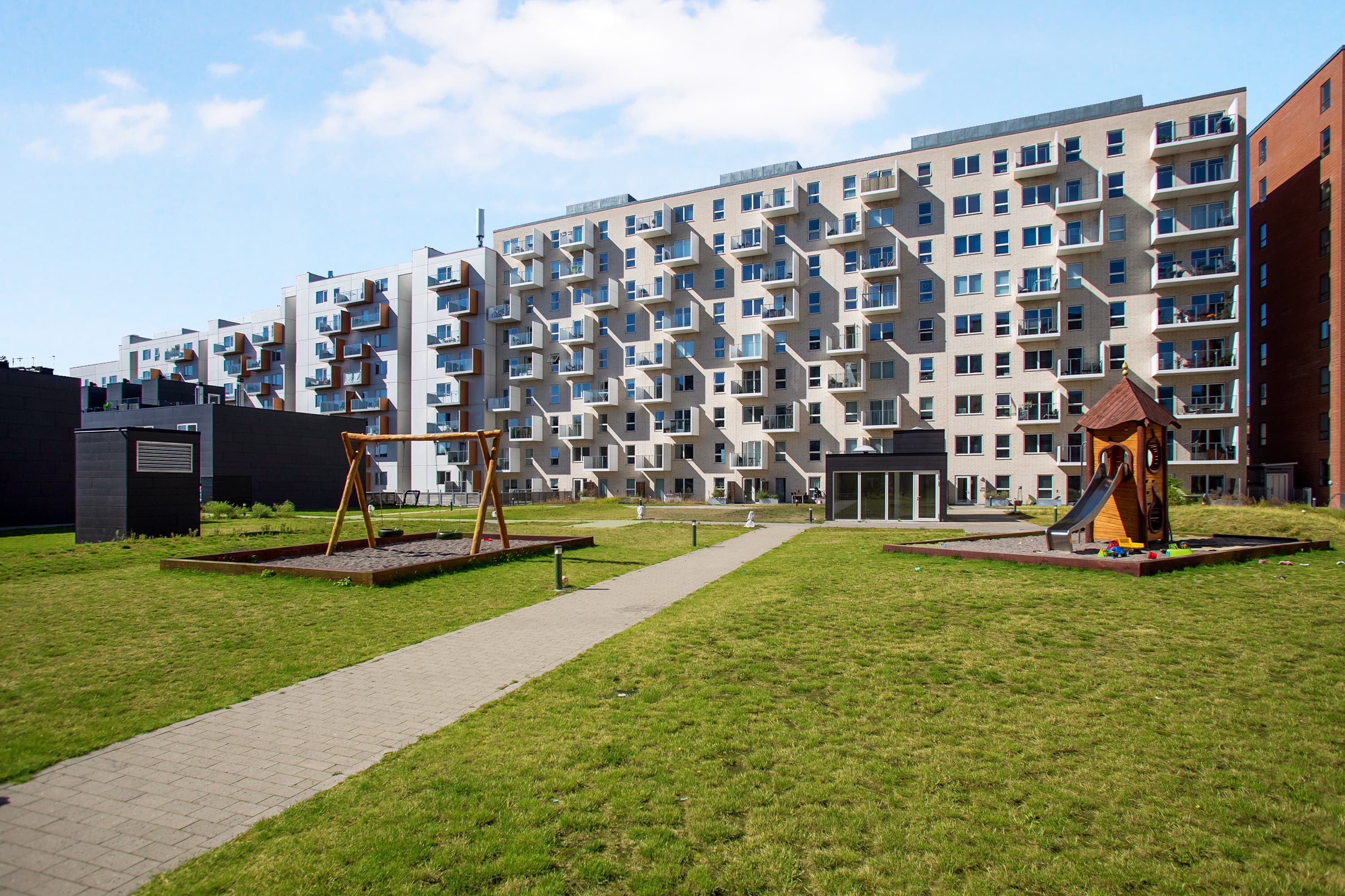 The courtyard at the Hesteskoen property with a swing and playground
