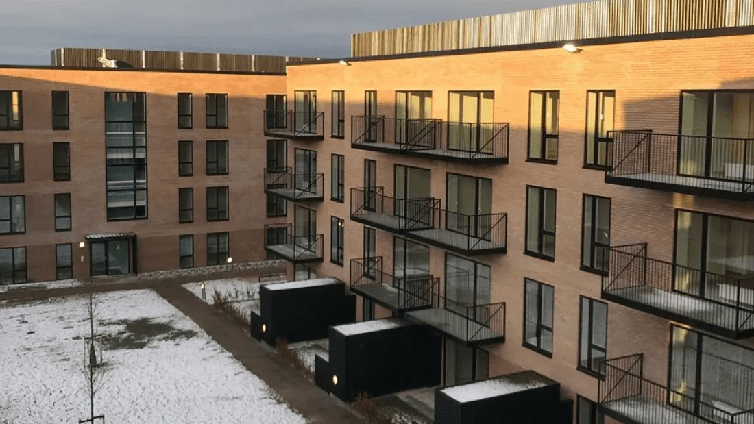 The property Agerhusene seen from the outside with balconies on the façade and a courtyard.