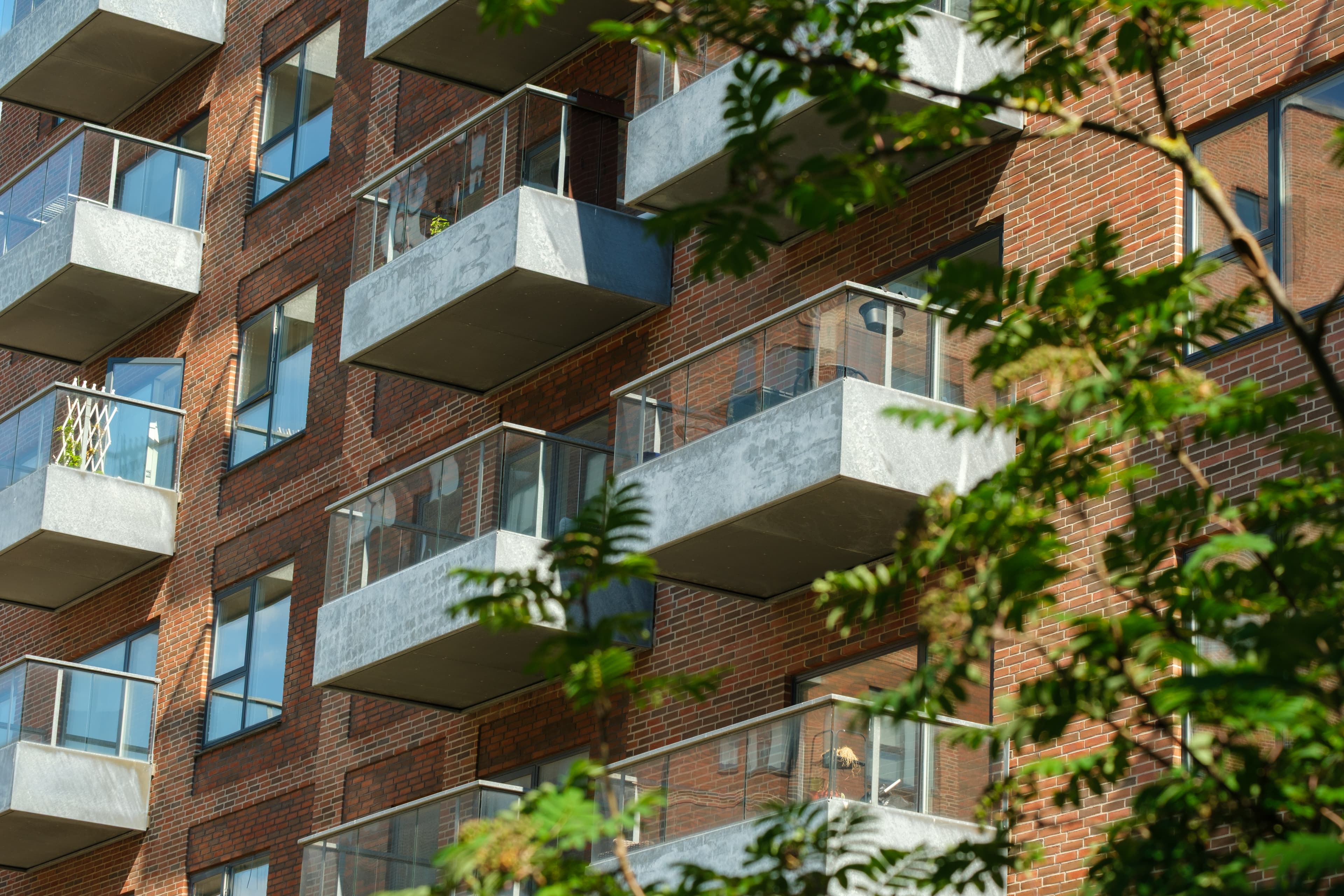Elsehus – Close-up of the Balconies with Green Landscaping in the Foreground