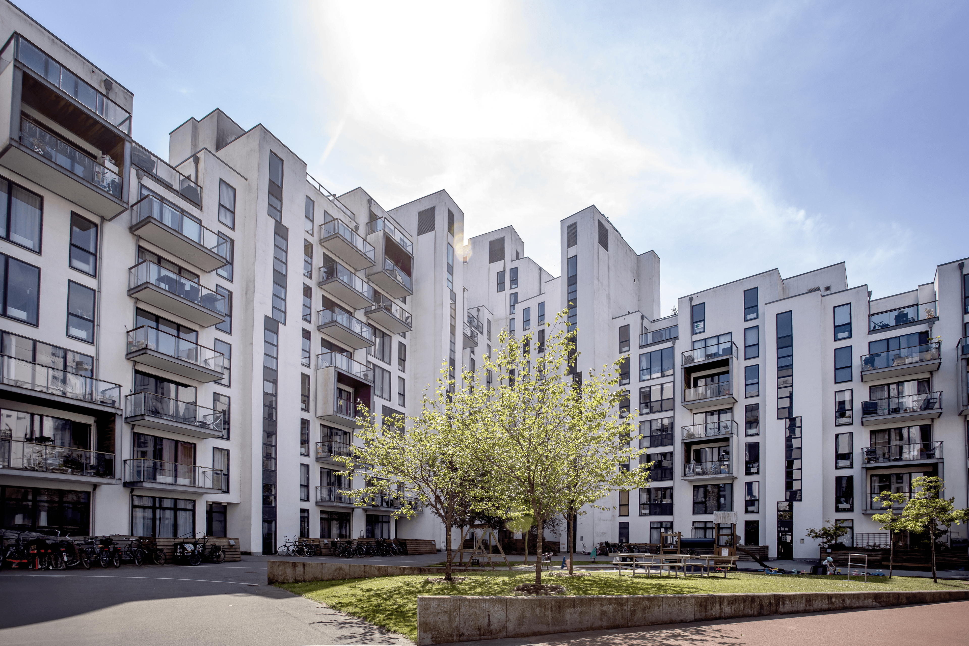 Exterior view of the courtyard at Stævnen showing shared outdoor areas.
