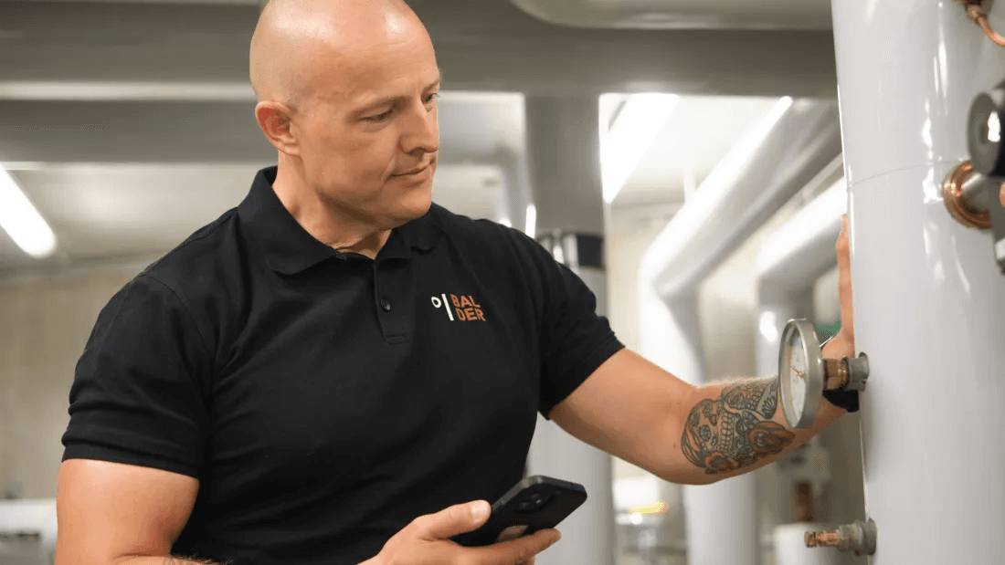 Martin, a Balder employee, checks the water heater in the property’s basement.