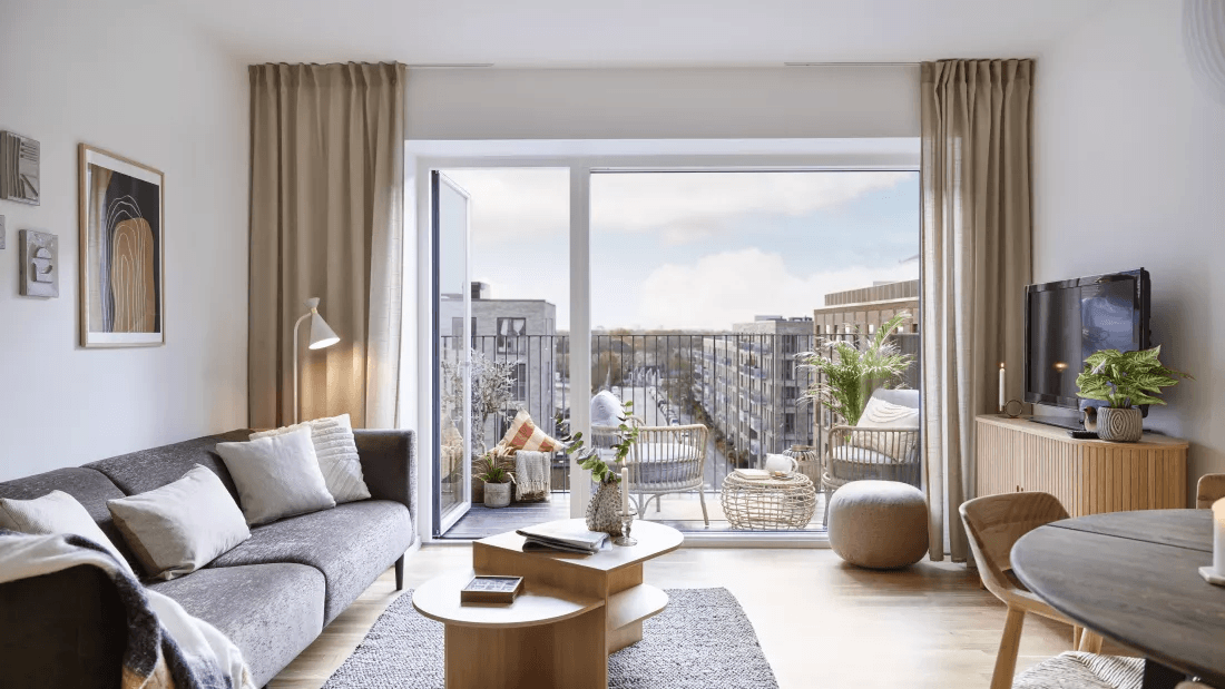 Visualisation showing a living room with a balcony in an apartment at Torveporten in Valby.