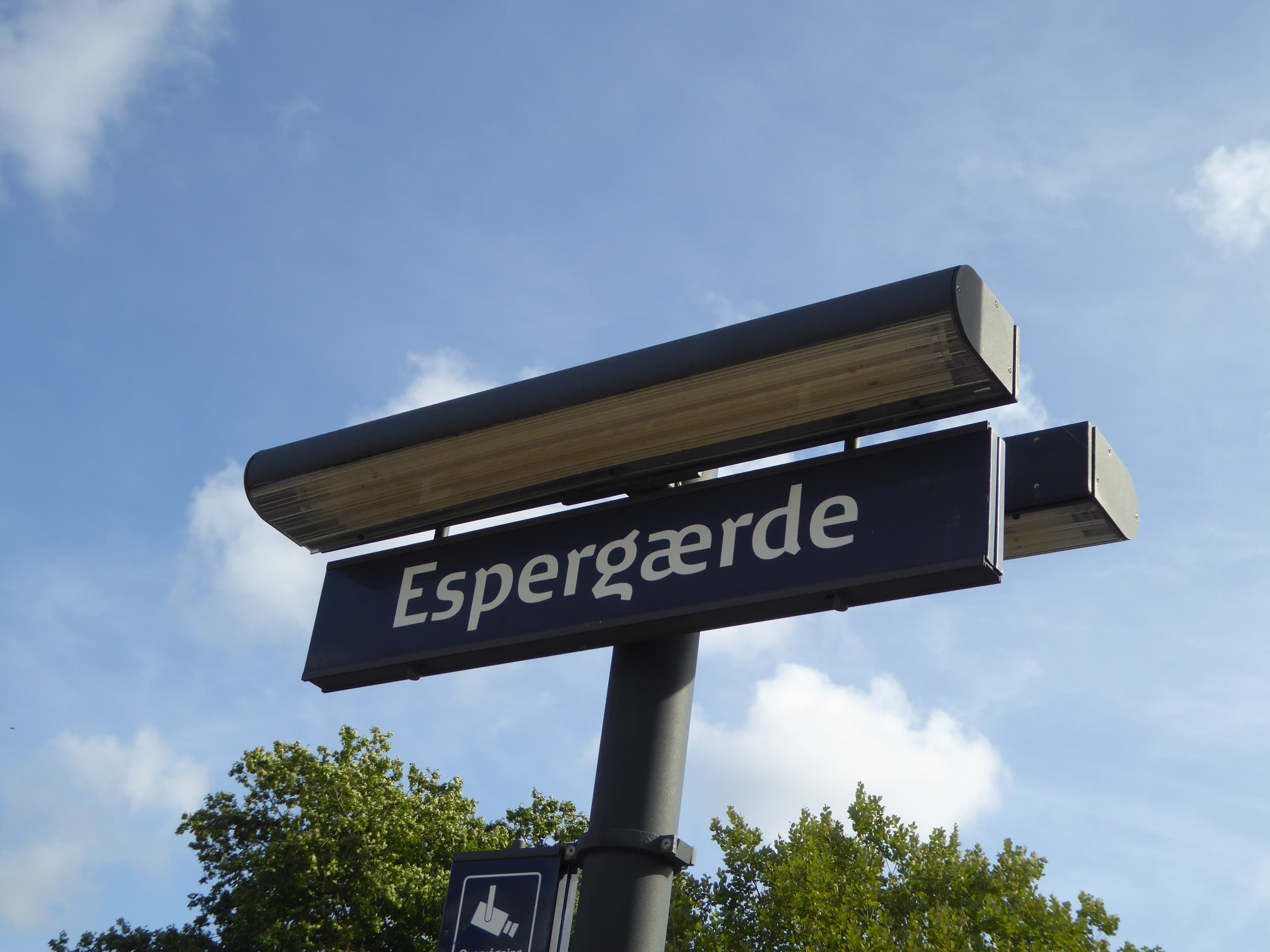 Espergærde Station sign against blue sky